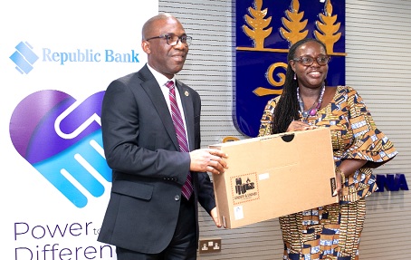 Benjamin Dzoboku, Managing Director of the bank, presenting one of the laptops to Professor Nana Aba Appiah Amfo, VC of the University of Ghana