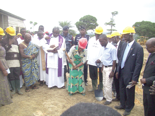 The Eastern Regional Minister, Ms Helen Adjoa Ntoso (with a pick-axe), cutting the sod to mark the beginning of the construction of the MCU School of Medical and Health Sciences at Larteh.
