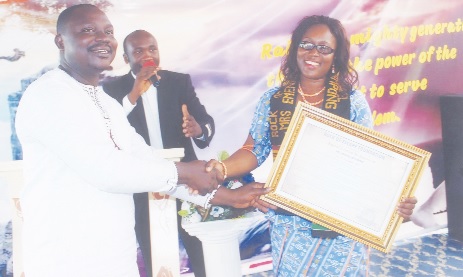 Mr Emmanuel Adjei Domson, founder of the Rock Escape Foundation (left), presenting a citation to Mrs Emenefa Acheampong (right) co-founder and head of the RisingSun Montessori School.  
