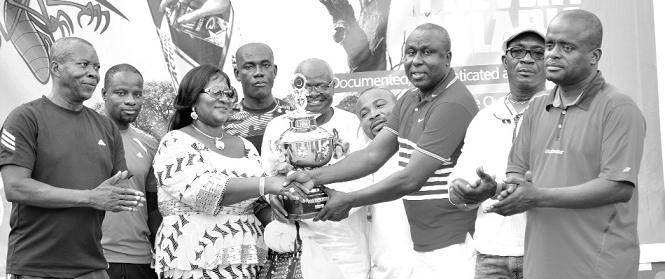 Mr and Mrs Dele of Evergreen Chemicals Limited presenting the trophy to the captain of 4 Garrison, S.S. Abebe.