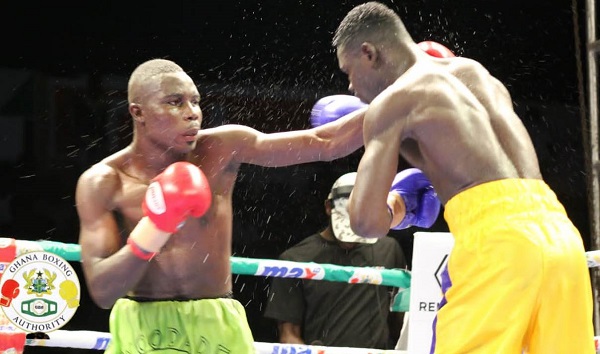 Musah Lawson connects to the jaw of his Lesko Sossiya (right) on his way to retaining his title last Saturday night