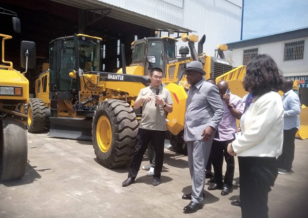 Mr Eric Fann, African Regional Manager of Shantui Construction Machinery Co Ltd conducting Dr Winfred Hammond, (in hat) Ghana's Ambassador to China round the facility. With them are Mr Isaac Ofori Poku, (3rd right) Executive Board Chairman, Ghana Bauxite company amd Ms Yang Yang, (right)  CEO, Zonda Tec Ghana.