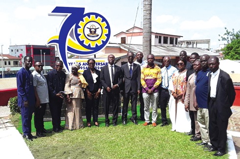 The university management standing in front of the anniversary logo after the unveiling