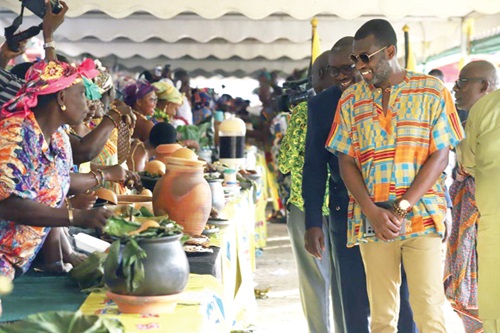 Mark Okraku-Mantey (right), Deputy Minister of Tourism, Arts and Culture, and some officials of the Ghana Tourism Authority observing some displayed meals during the Ghana Feast held at the Manhyia Palace in Kumasi