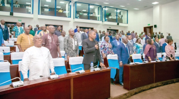 Members of the Togolese National Assembly on their feet for the playing of the country’s national anthem