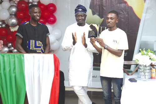 George Yawson Vineh (right), journalist, Pan African TV, launching the book. With him are Abdul-Karim Mohammed Awarf (middle) and Alidu Bayana (left), authors of the book. Picture: ELVIS NII NOI DOWUONA