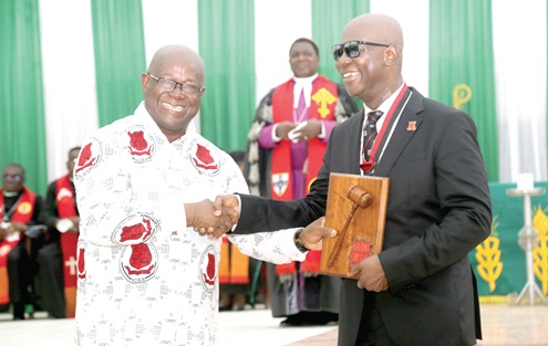 Capt. Paul Fordjoe (left), presenting the Instrument of Office to Moses Kwesi Baiden Jr. President of MOBA, at the  induction ceremony in Accra. Picture: SAMUEL TEI ADANO