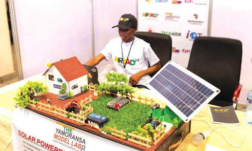 A participant showcasing a model of a solar-powered innovative project