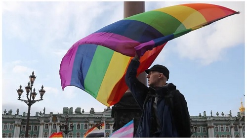A participant waves a rainbow flag during the St Petersburg Pride in 2019. Today, the flag would be considered a "symbol of extremism"