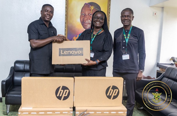 Dr Gideon Boako, spokesperson for the Vice- President (left) presenting one of the laptops to Prof Rita Akosua Dickson, Vice-Chancellor of the KNUST (second from right). With them is the Registrar of the school