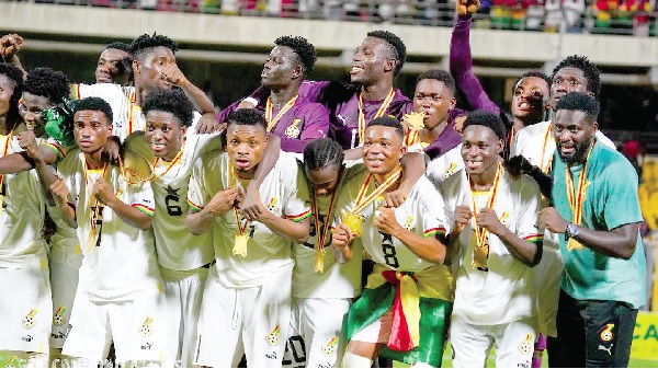 Players of the Black Satellites displaying their gold medals