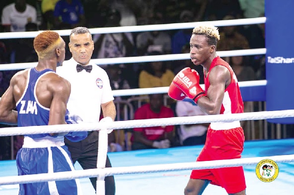 Samuel Takyi (right) competes against Zambian Emmanuel Katema in the final of the men’s 63.5kg weight category. 