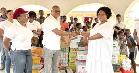 Eben-Kay Hodo (middle), the Managing Director of the school, handing over the cheque to Mary Kawsebea (right), Proprietress of the orphanage, while Pat Hodo (left), Executive Director in charge of Operations of the school, looks on