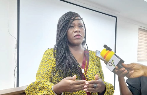Henrietta Lamptey (right), acting Registrar, Births and Deaths, speaking at the event  in Accra