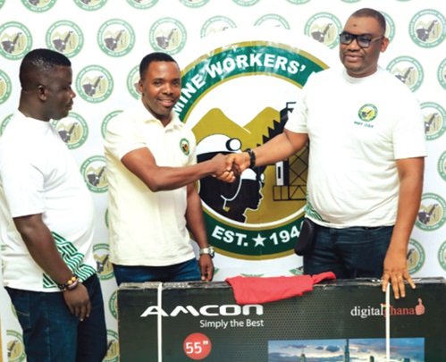 Abdul-Moonin Gbana (right), General Secretary of GMWU of TUC-Ghana, presenting the winning prize to Richard Amfoh Jnr (middle)