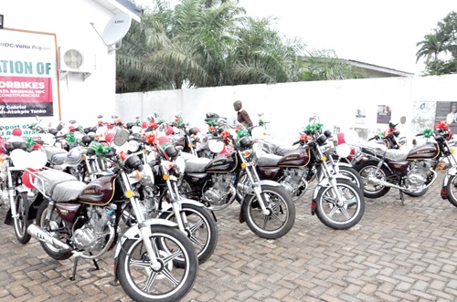 Prof. Joshua Alabi (right), National Vice-Chairman of NDC, and Mawutor Agbavitor (2nd from right) trying their hands on the bikes after the presentation. With them is Tanko Kwamigah-Atokple (middle).BELOW: Some of the bikes