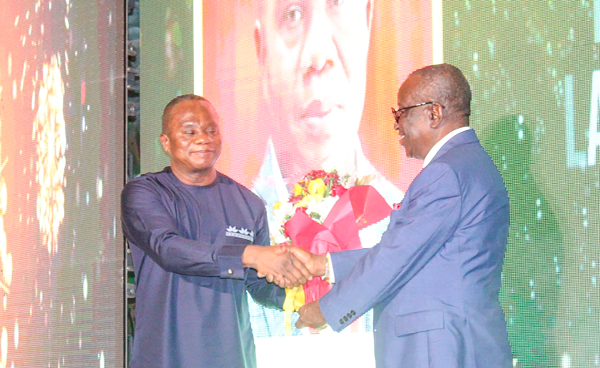 Albert Kan-Dapaah (right), Minister of National Security, presenting the award to Kizito Ballans (left), the Chief Director of Ministry of Employment and Labour Relations