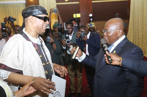 President Akufo-Addo presenting a passport to Steve Wonder to indicate his citizenship at a ceremony at the Jubilee House. Picture: SAMUEL TEI ADANO