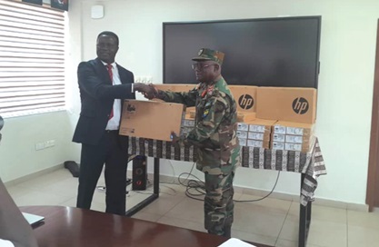 Brigadier General Barima Brako Owusu (right), Chief Staff Officer, Army Headquarters, receiving one of the laptops from Dr Yaw Osei Adutwum, Education Minister 