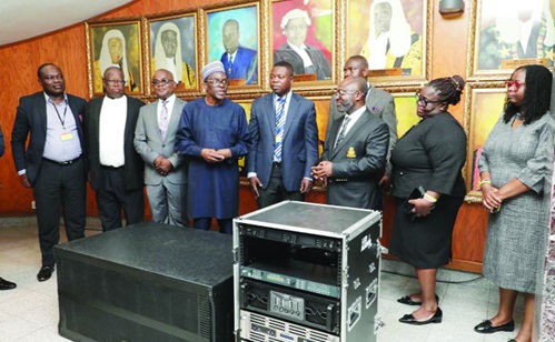 Alban S.K. Bagbin (4th from left), the Speaker of Parliament, handing over the equipment to Barima Yaw Kodie Oppong (3rd from right), the Director of the Ghana School of Law