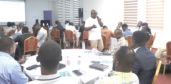 Eric Kafui Bansah (with microphone), Principal Manager, Capacity Building and Awareness Creation, Cyber Security Authority, in a discussion with participants during a training session. Picture: EDNA SALVO-KOTEY