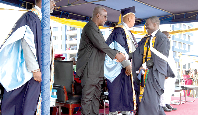 President Mahama congratulating one of the graduands.