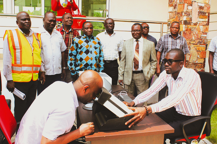 A journalist being taken through a trial of the DVLA Express Mobile Services, as Noble John Appiah (arrowed) and other officials of the DVLA look on in admiration. Picture: NII MARTEY M. BOTCHWAY