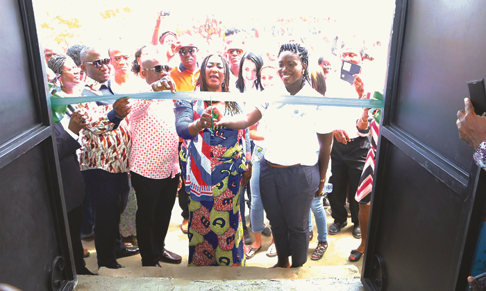 The New Patriotic Party Parliamentary Candidate for Weija-Gbawe, Mrs Tina Mensah (2nd right), and Samantha Boateng (right), cutting the tape to formally inaugurate the library.