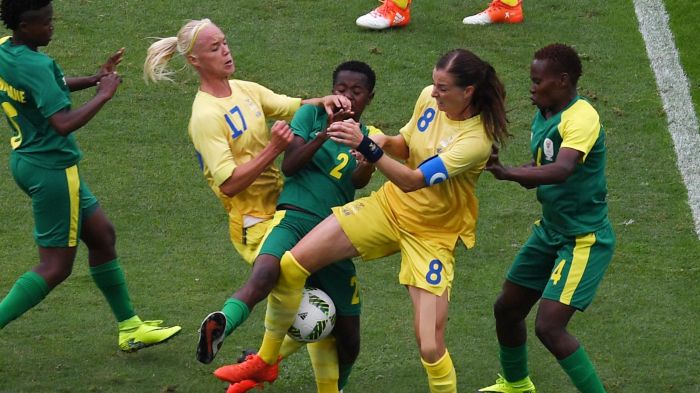 Swedish players Caroline Seger (2-L) and Lotta Schelin (2-R) sandwich a South African player