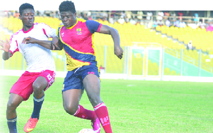 Abdul Ibrahim of Wafa (left) closes down on Hearts of Oak's Ibrahim Musa during their first round clash at the Accra Sports Stadium.