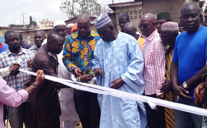 The Member of Parliament(MP) for Ayawaso East, Mr Nasser Mahama Toure (3rd from left), lending support to the Chairman of the Council of Zongo Chiefs, Chief Umaru Baba Issah, to inaugurate the bridge