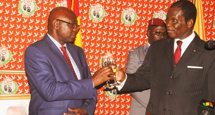 A Minister of State at the Presidency, Mr Akwasi Oppong Fosu (left) and the Ivorian Ambassador to Ghana,  Mr Bernard Ehui-Koutoua toasting to the peace of the two countries