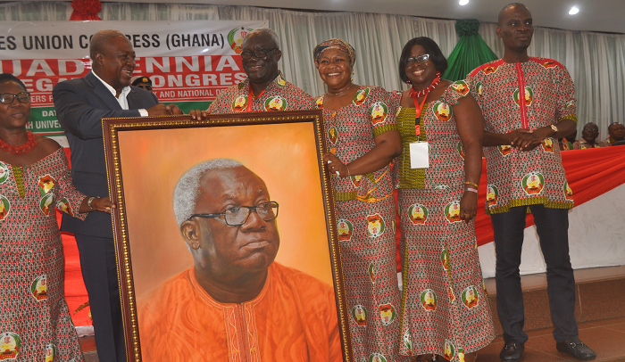  President Mahama (2nd left), on behalf of members of the TUC, presenting a portrait to Mr Kofi Asamoah (3rd left), Secretary-General, TUC, for his dedicated service, during the TUC’s 10th Quadrennial Delegates Congress in Kumasi. Those with them are Mr Haruna Iddrisu (right), the Minister of Employment and Labour Relations, and some members of the TUC. Picture: EMMANUEL BAAH