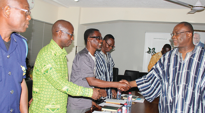 Dr Ekwow Spio-Garbrah (right) congratulating members of the committee after the inauguration