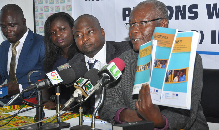 Mr Samuel Asare Akuamoah (right), acting Chairman, NCCE, launching a guideline of the Ghana Federation of Disability Organisation (GFD) in Accra. With him are Mr Mohammed Abdul Aziz (2nd right), Executive Board Member, GFD, and Mrs Rita Kyeremaa Kusi (3rd left), CEO, GFD. Picture: SAMUEL TEI ADANO