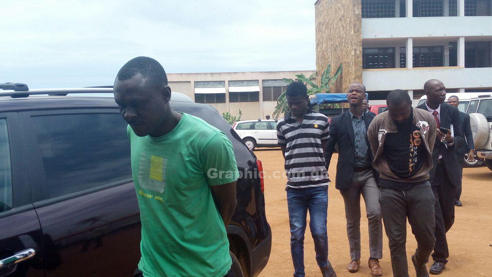 The three accused persons being escorted out of the court premises
