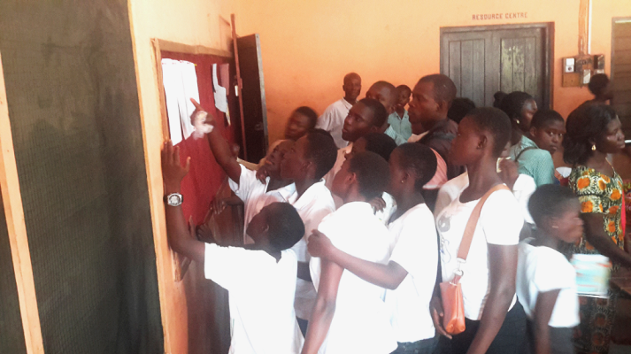 Anxious pupils going through the admission list to see whether they have been selected or not.