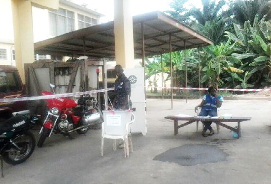 A security personnel cast his vote at the Fire Service centre in Cape Coast North.