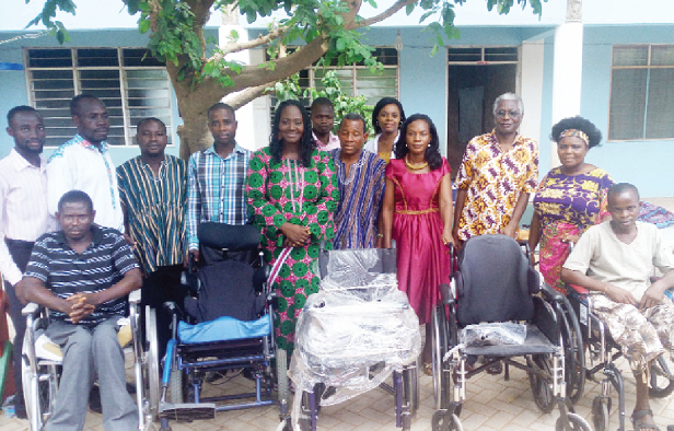  Mrs Gladys Addo Osei (in green African fabric), some of the recipients of the wheel chairs and some opinion leaders in the electoral area.