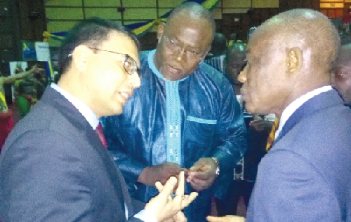 Mr Seth Terkper (right) and Mr Ekwow Spio-Garbrah (middle) interacting with a participant after the event