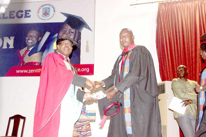   Mr Emmanuel Tetteh (right), a staff of Graphic Communications Group Limited receiving his MBA certificate from Mr Stephen Takyi-Asiedu. Picture: NII MARTEY BOTCHWAY 