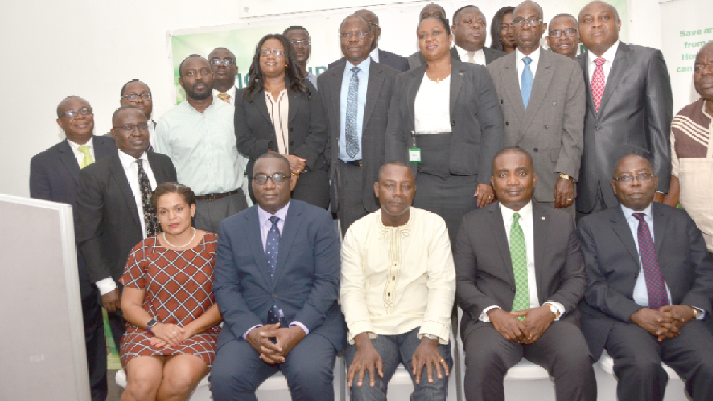  Mr Daniel Asiedu (seated 2nd right) and Mr K.S. Yamoah (right) with stakeholders of the bank
