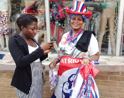 Ms Sarah Micah (right) clad in different paraphernalia of the NPP