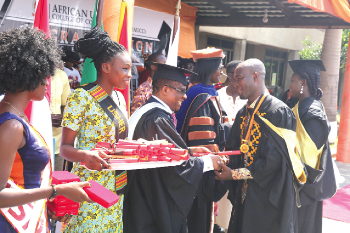   Samuel Tei Adano of the Graphic Communications Group Limited receiving his certificate from Nana Banyin Dadson, Head of Journalism. 