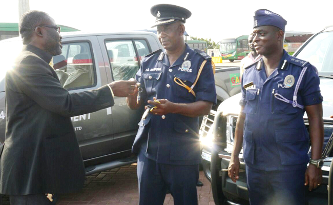 Mr Michael Konadu (left) handing over keys to the vehicles to ACP Patrick Adusei Sarpong. Picture: PATRICK DICKSON