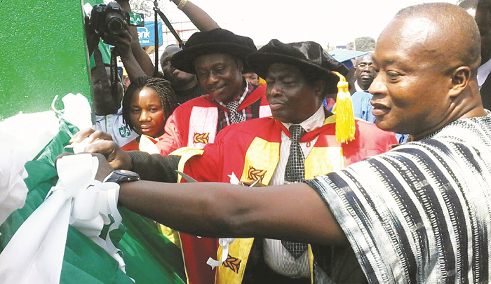   Mr Justice Samuel Adjei (right), Prof. Kwame Agyenim Boateng (middle), Chairman of the University Council, and Prof. Kwadwo Adinkrah-Appiah  jointly unveiling a plaque to inaugurate the university.