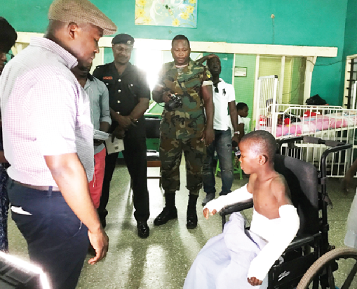 The Chief Executive Officer of the Ghana Chamber of Bulk Oil Distributors (CBOD), Mr Senyo Hosi, with one of the victims, William Bansah, at the children's ward, 37 Military Hospital