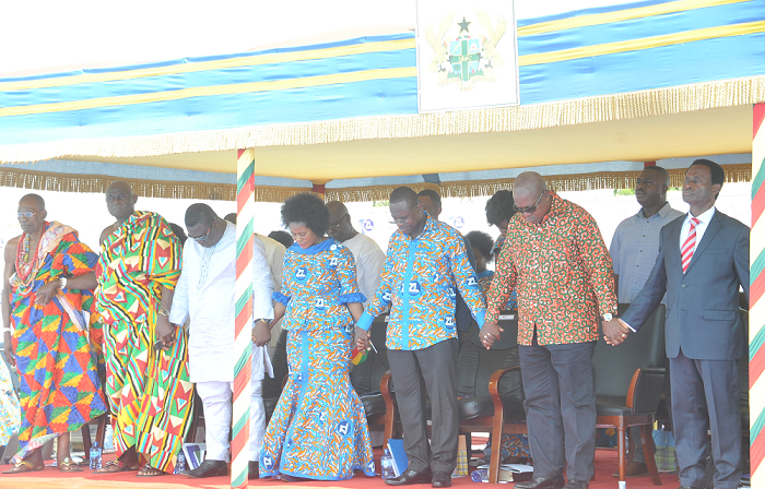  President Mahama (2nd right) joins hands with Dr Siaw Agyepong to pray for the nation and the company at the ceremony.