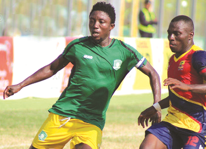  Aduana Stars skipper Godfred Saka battles with Patrick Razak (right) of Hearts for the ball