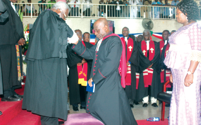Rt. Rev. Prof. Martey (left), immediate past Presby Moderator,  praying for Rt. Rev. Prof. Cephas Omenyo. With them is  Mrs Rosekell Omenyo (right).  PHOTO: Mercy Amparbeng